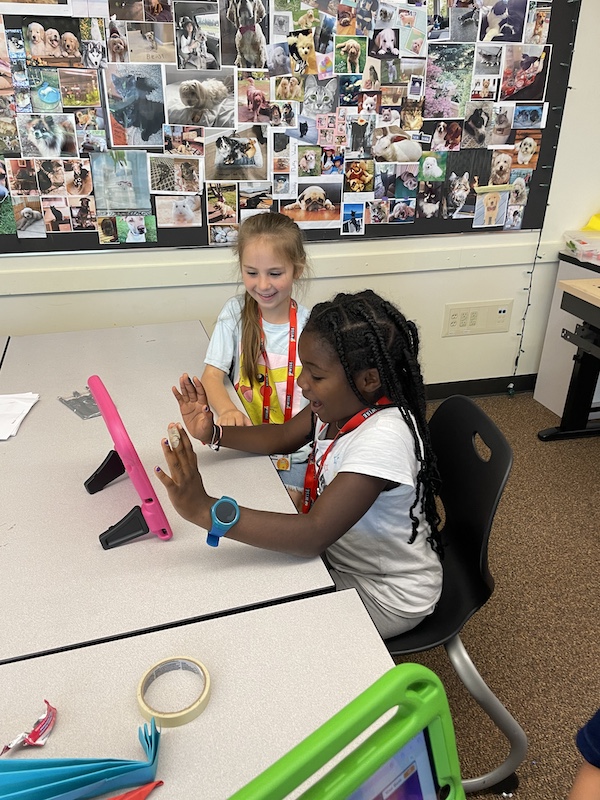 Bellevue Summer Camps Wise Camps campers engaged on iPad math activities at the Magic Math station.