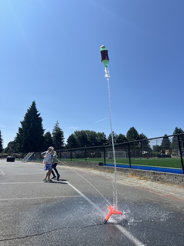 Bellevue Summer Camps Wise Camps campers shooting a water bottle rocket at the Rocket Scientists station.